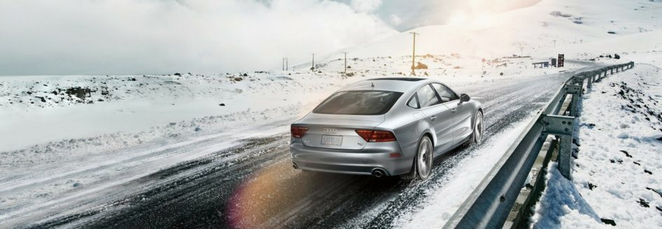 An Audi A7 driving down a snowy road featured in a blog post about Audi parts