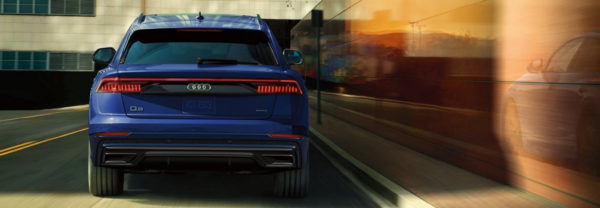 A 2019 Audi Q8 driving away down the street