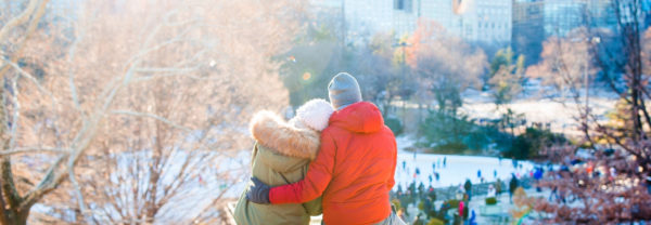 A couple overlooking a snow-covered park in New York City, NY